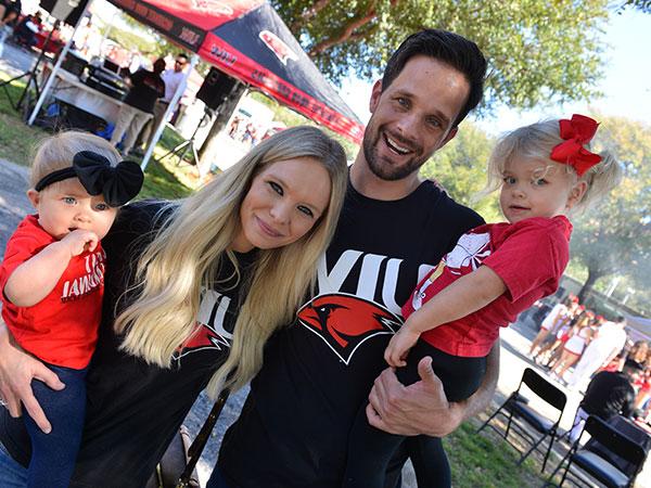 Family at tailgate smiling, husband, wife and children