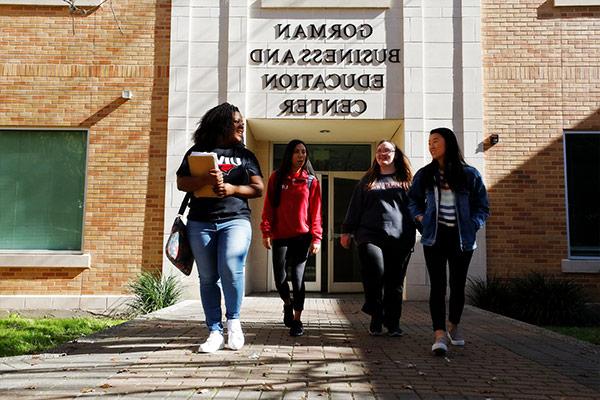 Students walking in front of business building