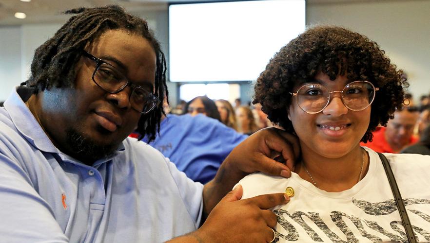 two participants at pinning event